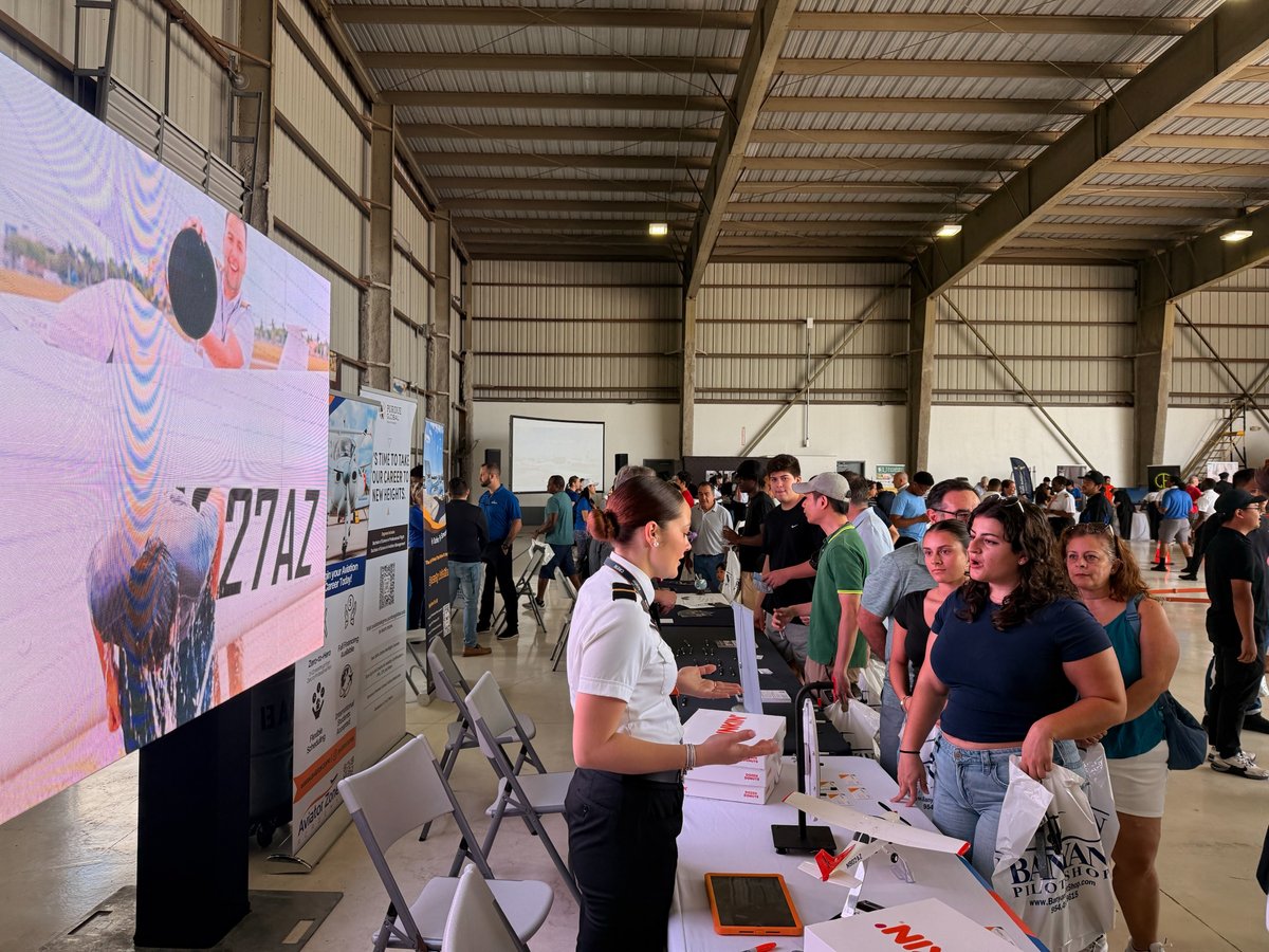 Nicole Santiago speaking with students at an aviation expo